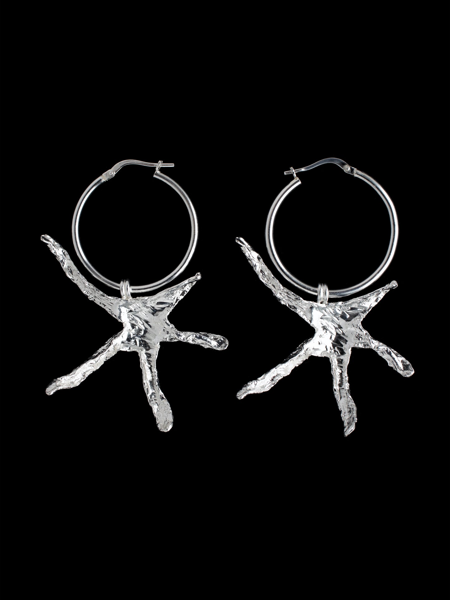 Large organic star shaped hoop earrings handmade in silver